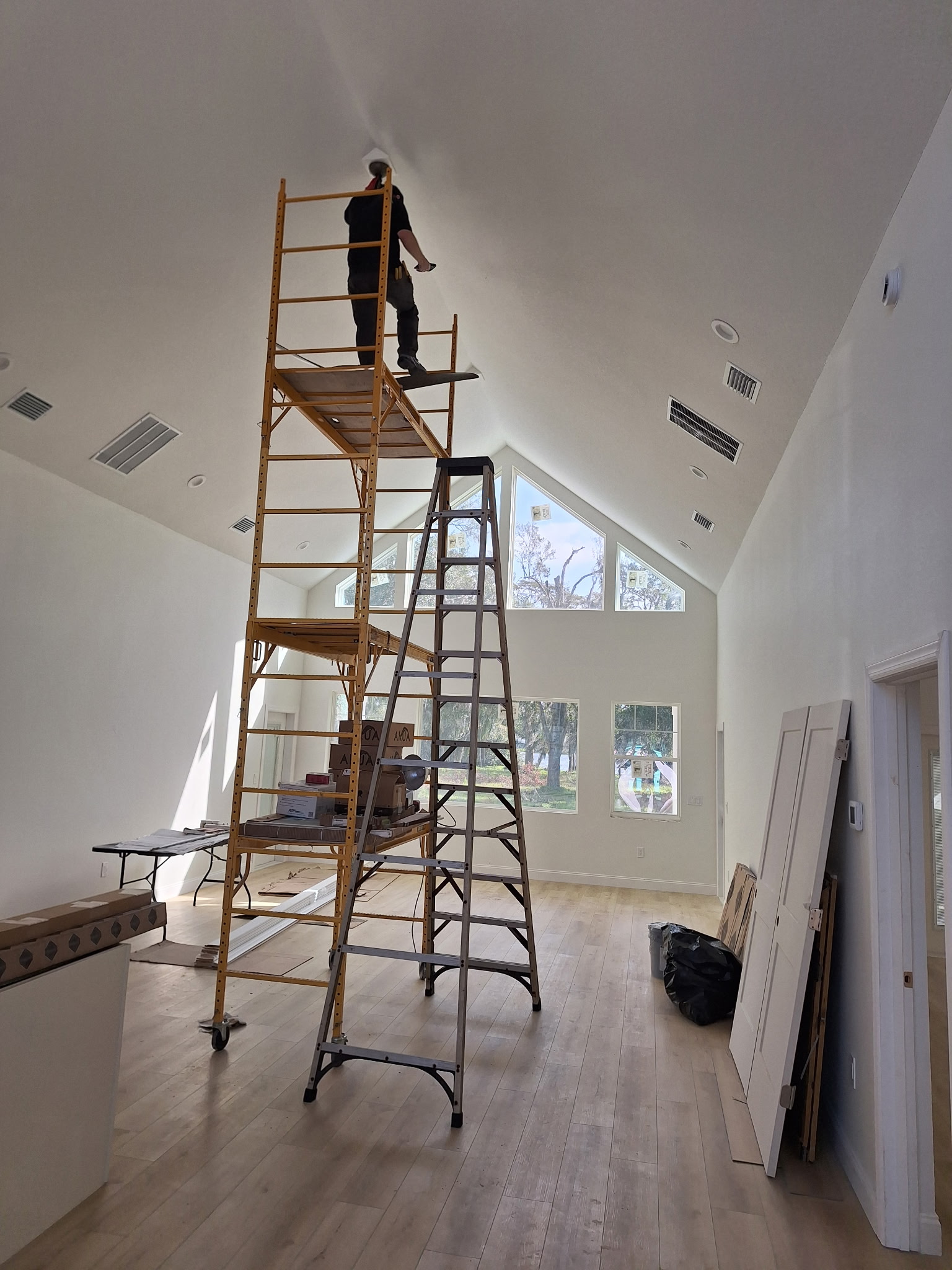 Vaulted ceiling install on scaffold